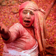 A widow sings religious songs as she takes part in the Holi celebrations.